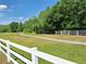Scenic view of a walking path with a white fence, surrounded by lush greenery at 19855 Ellendale Dr, Land O Lakes, FL 34638