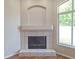 Living room featuring a tiled fireplace with mantle and hearth, adjacent to a large window at 19855 Ellendale Dr, Land O Lakes, FL 34638