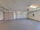 Spacious three car garage with painted floor and updated lighting at 19855 Ellendale Dr, Land O Lakes, FL 34638