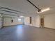Spacious three car garage with painted floor and updated lighting at 19855 Ellendale Dr, Land O Lakes, FL 34638