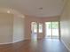Spacious living room with modern flooring, an arched doorway, and sliding glass doors to the yard at 19855 Ellendale Dr, Land O Lakes, FL 34638