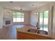 This open-concept living area features a beautiful fireplace, big windows, and backyard access at 19855 Ellendale Dr, Land O Lakes, FL 34638