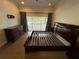 Bright bedroom with wood floors, ceiling fan and sliding doors to the backyard patio at 210 S Hale Ave, Tampa, FL 33609