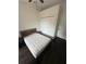 Bedroom featuring a neutral color palette, ceiling fan, closet, and dark wood flooring at 210 S Hale Ave, Tampa, FL 33609