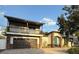Beautiful two-story home with a covered balcony, stone accents, and a paved driveway at 210 S Hale Ave, Tampa, FL 33609