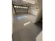 View of the garage with epoxy floor, storage and garage door with natural light streaming in at 210 S Hale Ave, Tampa, FL 33609