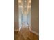 Hallway with tile flooring, neutral walls, and multiple doors that suggest access to different areas of the house at 210 S Hale Ave, Tampa, FL 33609