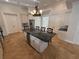 The eat-in kitchen features white cabinets, a dark island, and a view of the adjacent rooms at 210 S Hale Ave, Tampa, FL 33609