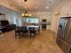 Open kitchen featuring stainless appliances, an island with a black countertop, and abundant natural light at 210 S Hale Ave, Tampa, FL 33609