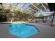 A beautiful screened-in pool with a hot tub and lovely landscaping provides a private backyard oasis at 210 S Hale Ave, Tampa, FL 33609