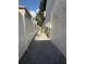 View of the side yard with gravel, white vinyl fence, and exterior utilities at 210 S Hale Ave, Tampa, FL 33609
