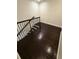 Dark wood staircase with matching wood floors, complemented by a simple dark iron railing at 210 S Hale Ave, Tampa, FL 33609