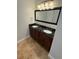 Bathroom vanity featuring dual sinks, dark granite countertop, and wood cabinets at 210 S Hale Ave, Tampa, FL 33609