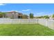 Expansive backyard with lush green grass and a white picket fence at 21167 Pleasant Plains Pkwy, Land O Lakes, FL 34637