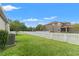 A charming backyard featuring a white picket fence and lush green lawn, perfect for outdoor activities at 21167 Pleasant Plains Pkwy, Land O Lakes, FL 34637