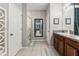 Functional bathroom showcasing dual sinks, ample counter space, and a mirror extending into the hallway at 21167 Pleasant Plains Pkwy, Land O Lakes, FL 34637