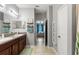 Functional bathroom features dual sinks, storage, and a mirror that gives access to the bedroom at 21167 Pleasant Plains Pkwy, Land O Lakes, FL 34637