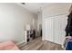 Cozy bedroom with wood floors, a closet, a modern vanity and a storage shelf at 21167 Pleasant Plains Pkwy, Land O Lakes, FL 34637