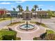 Stunning clubhouse entrance with fountain, landscaped beds, and benches offering welcoming curb appeal at 21167 Pleasant Plains Pkwy, Land O Lakes, FL 34637