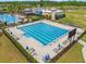 Aerial view of an Olympic-size pool surrounded by lounge chairs and lush landscaping at the community center at 21167 Pleasant Plains Pkwy, Land O Lakes, FL 34637