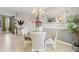 Cozy dining area with modern chandelier, mirror, and decor that offers a comfortable and inviting atmosphere at 21167 Pleasant Plains Pkwy, Land O Lakes, FL 34637