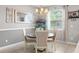 Bright dining room features a stylish chandelier, large mirror, and comfortable seating for a modern dining experience at 21167 Pleasant Plains Pkwy, Land O Lakes, FL 34637