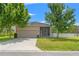 Well-maintained home featuring an attached two-car garage, screened lanai, and a white picket fence at 21167 Pleasant Plains Pkwy, Land O Lakes, FL 34637