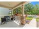 Charming front porch with stone pillars and views of the landscaped yard at 21167 Pleasant Plains Pkwy, Land O Lakes, FL 34637