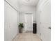 Hallway with tile flooring, and plenty of storage space in the closet at 21167 Pleasant Plains Pkwy, Land O Lakes, FL 34637