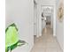Bright hallway with tile flooring and views of the living room and kitchen at 21167 Pleasant Plains Pkwy, Land O Lakes, FL 34637