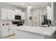 Well-equipped kitchen featuring white cabinets, quartz countertops, stainless appliances, and tile flooring at 21167 Pleasant Plains Pkwy, Land O Lakes, FL 34637