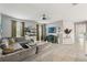 Inviting living room features a sectional sofa, modern decor, tile flooring and large windows at 21167 Pleasant Plains Pkwy, Land O Lakes, FL 34637