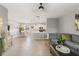 Open-concept living area features tile flooring, a comfortable sofa, and a view of the dining and kitchen area at 21167 Pleasant Plains Pkwy, Land O Lakes, FL 34637