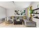 Bright and open living room with tile floors and a comfortable sectional sofa with an ottoman at 21167 Pleasant Plains Pkwy, Land O Lakes, FL 34637