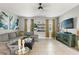 Bright living room features comfortable seating, neutral walls, tile flooring and a television at 21167 Pleasant Plains Pkwy, Land O Lakes, FL 34637