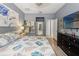 Comfortable main bedroom features modern decor, hardwood floors, and a television for relaxing evenings at 21167 Pleasant Plains Pkwy, Land O Lakes, FL 34637