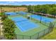Aerial view of tennis courts within a community, offering residents recreational opportunities in a beautiful setting at 21167 Pleasant Plains Pkwy, Land O Lakes, FL 34637