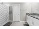 Bright bathroom with double vanity, granite countertops, shower and a patterned shower curtain at 2132 Shining Azul Way, Lutz, FL 33558