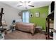 Well-lit bedroom with a ceiling fan, window and unique wall decor at 2132 Shining Azul Way, Lutz, FL 33558