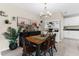 Charming dining room with decorative furnishings, decorative lighting, and a rustic table with seating for four at 2132 Shining Azul Way, Lutz, FL 33558