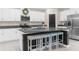 Modern kitchen featuring white cabinetry, stainless steel appliances, granite countertops, and a spacious island with seating at 2132 Shining Azul Way, Lutz, FL 33558