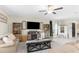 Spacious living room with ceiling fan, neutral tones, comfortable seating, tile floor, and a modern decor at 2132 Shining Azul Way, Lutz, FL 33558