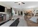 Open-concept living area with a ceiling fan, neutral tones, comfortable seating, and seamless flow to dining area at 2132 Shining Azul Way, Lutz, FL 33558