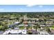 An aerial view showcases the property nestled within a thriving community, close to local amenities and green spaces at 2175 Edythe Dr, Dunedin, FL 34698
