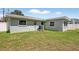 Expansive backyard with lush green grass surrounding the home at 2175 Edythe Dr, Dunedin, FL 34698