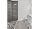 Modern bathroom featuring a tiled shower, white vanity, and neutral color palette at 2175 Edythe Dr, Dunedin, FL 34698