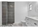 Contemporary bathroom featuring a tiled shower, white vanity, and ample natural light at 2175 Edythe Dr, Dunedin, FL 34698