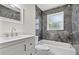 Stylish bathroom featuring tub, granite tile, and white vanity at 2175 Edythe Dr, Dunedin, FL 34698