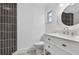 Bathroom with unique tiles, vanity, modern fixtures, and a framed mirror at 2175 Edythe Dr, Dunedin, FL 34698
