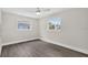 Bright bedroom with hardwood floors and two windows offering natural light at 2175 Edythe Dr, Dunedin, FL 34698